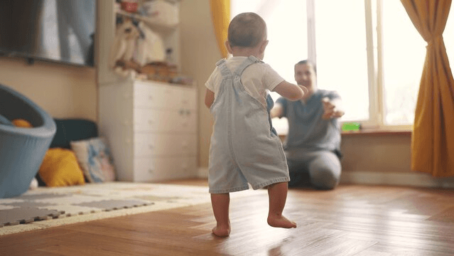 Illustrated video thumbnail of a baby taking first steps beside a coffee table